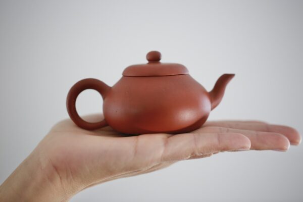 Zisha teapot on top of hand